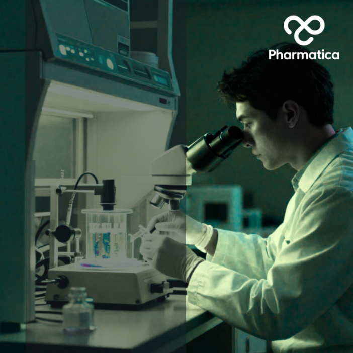 A scientist in a lab coat and gloves looking through a microscope at a workstation, with the Pharmatica logo in the bottom left corner.