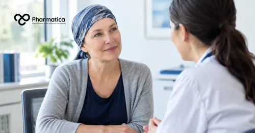 Pharmatica image of a female cancer patient speaking with an oncologist in a naturally lit consultation room.